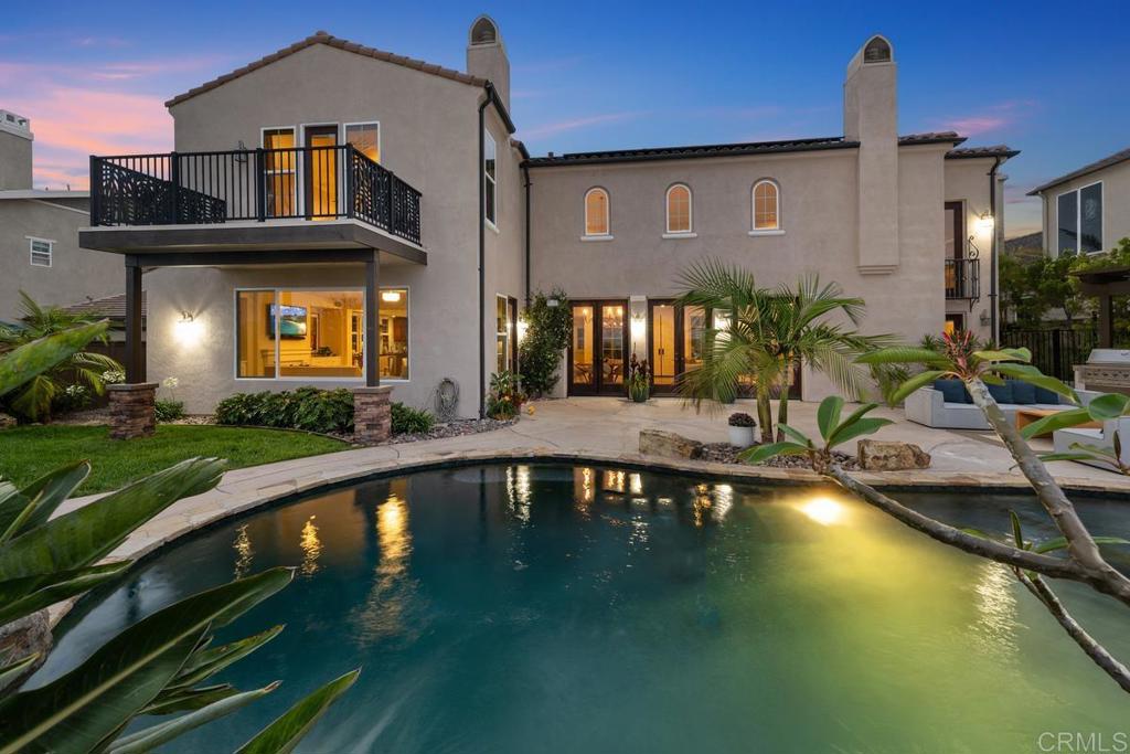 7603 Circulo Sequoia Carlsbad, CA 92009 - Photo 22 of 61 a front view of a house with swimming pool having outdoor seating
