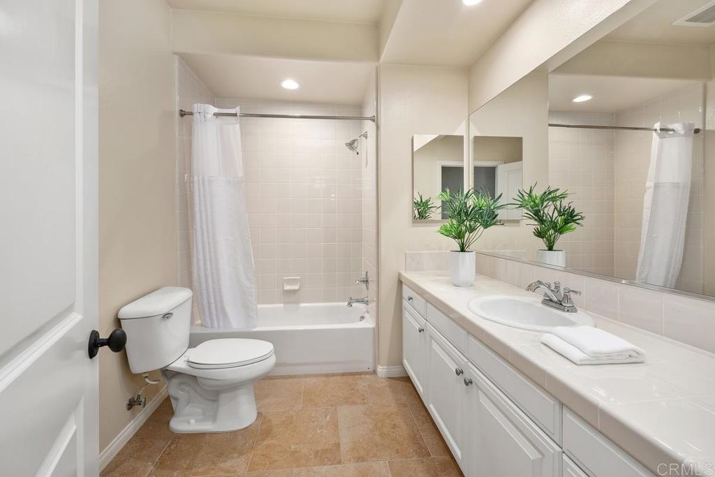 7603 Circulo Sequoia Carlsbad, CA 92009 - Photo 35 of 61 a bathroom with a sink a toilet and a large mirror
