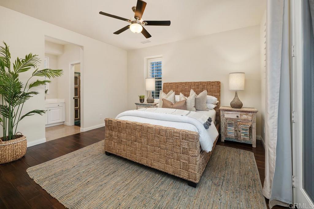 7603 Circulo Sequoia Carlsbad, CA 92009 - Photo 37 of 61 a bedroom with a large bed and a potted plant
