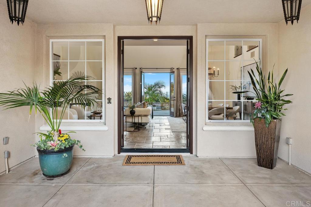 7603 Circulo Sequoia Carlsbad, CA 92009 - Photo 41 of 61 a view of a entryway door and potted plant in front of a house