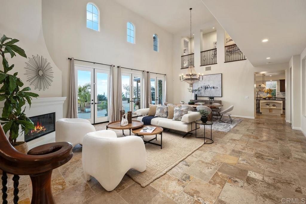 7603 Circulo Sequoia Carlsbad, CA 92009 - Photo 9 of 61 a living room with furniture a fireplace and a potted plant