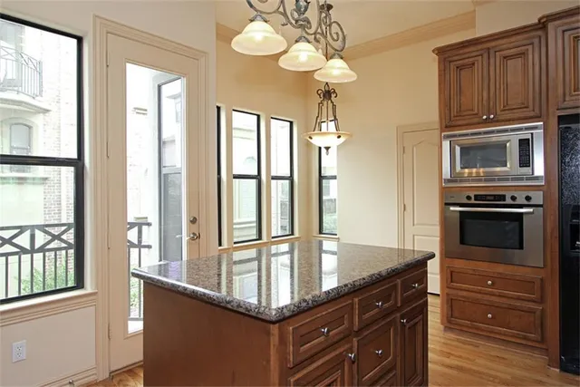 a kitchen with stainless steel appliances granite countertop a stove and a microwave