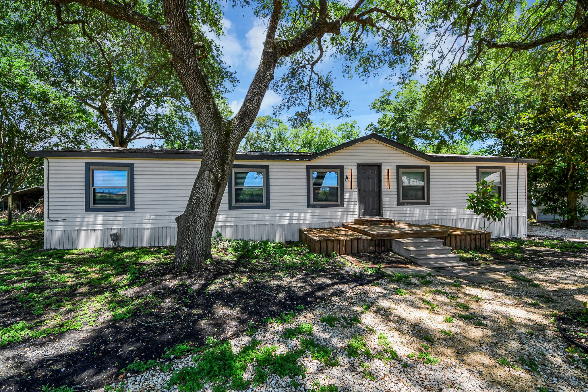 28222 Margerstadt Road Waller, TX 77484 - Photo 2 of 50 Charming manufactured home nestled beneath towering shade trees.