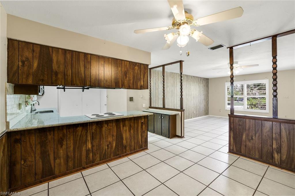 5290 Cypress Lane Naples, FL 34113 - Photo 39 of 39 a kitchen with a sink window and cabinets
