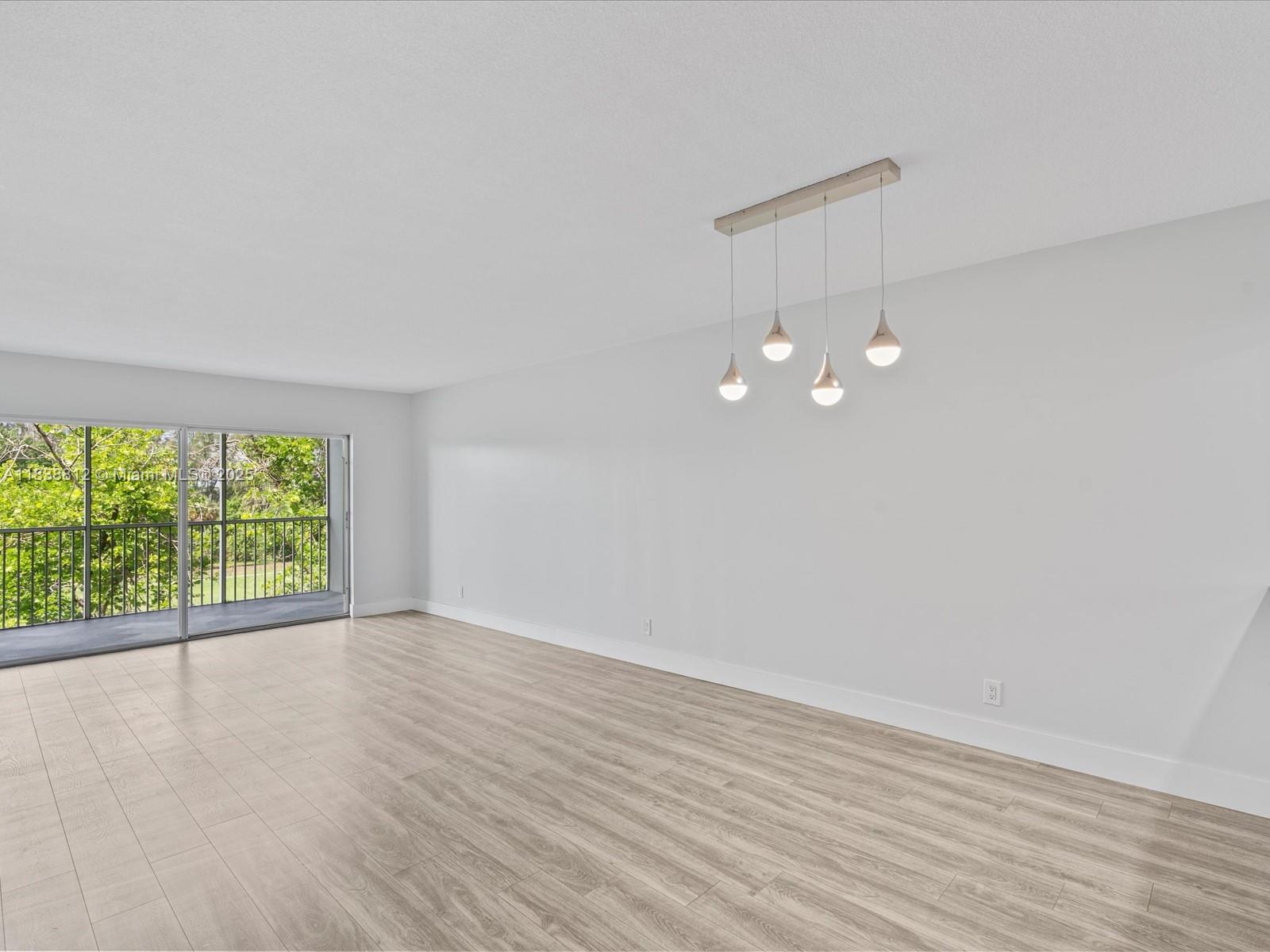 Palm Aire Pompano Beach, FL 33069 - Photo 12 of 26 wooden floor in an empty room with a window