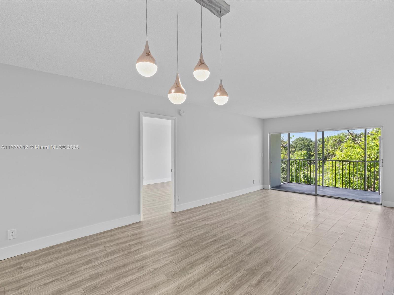 Palm Aire Pompano Beach, FL 33069 - Photo 13 of 26 a view of an empty room with wooden floor and windows