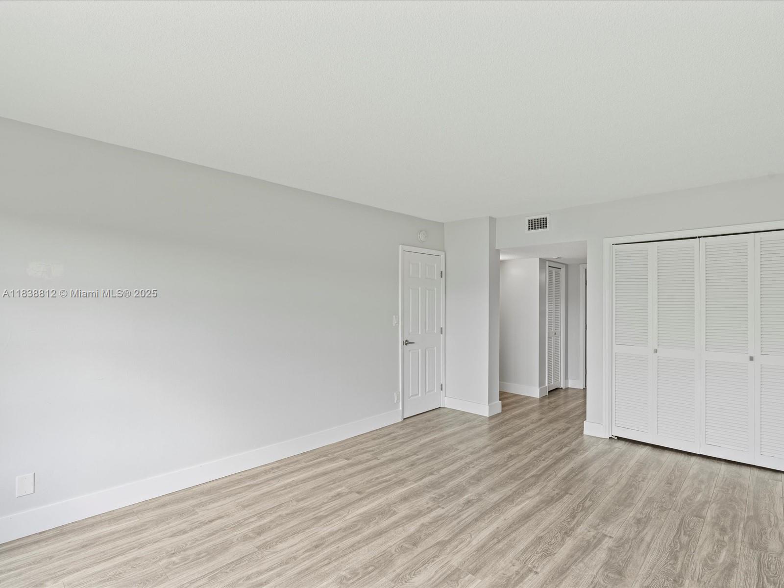 Palm Aire Pompano Beach, FL 33069 - Photo 15 of 26 a view of an empty room and wooden floor