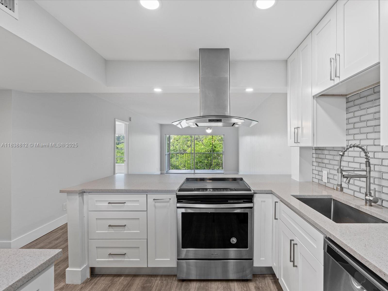 Palm Aire Pompano Beach, FL 33069 - Photo 2 of 26 a kitchen with stainless steel appliances a stove sink and cabinets