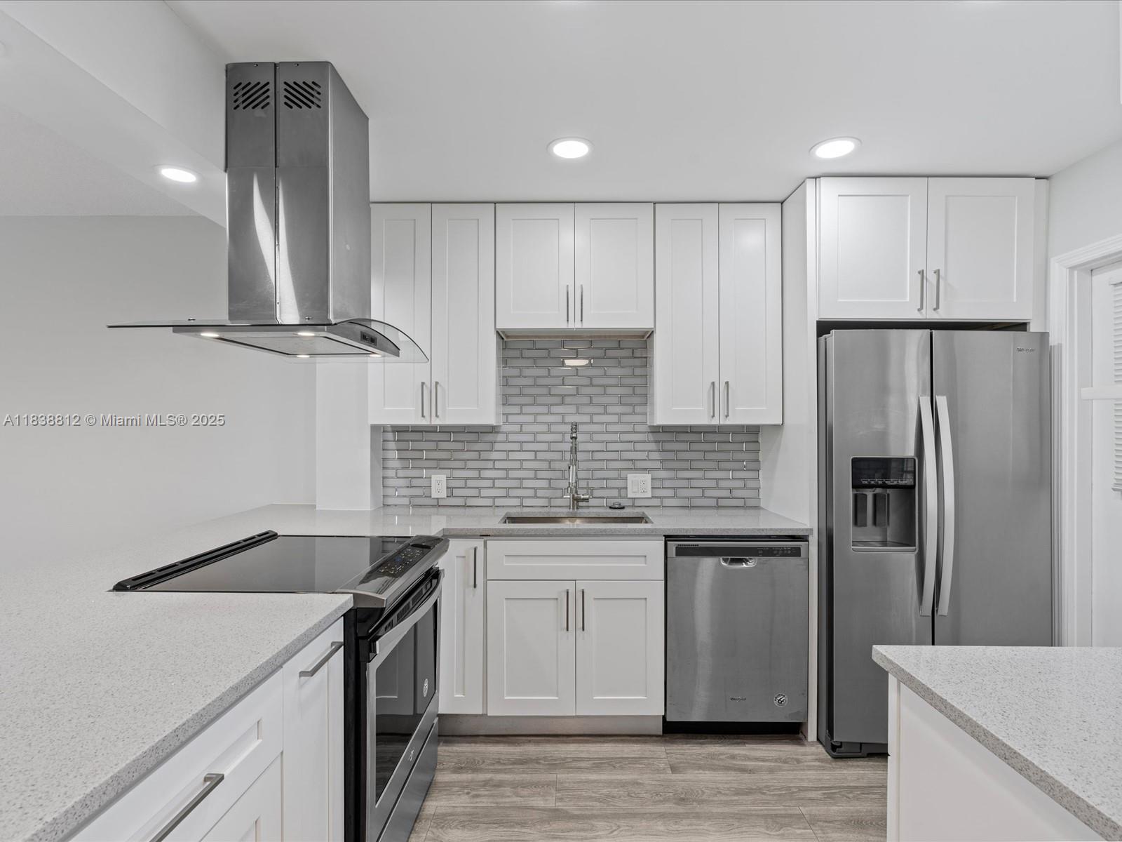 Palm Aire Pompano Beach, FL 33069 - Photo 3 of 26 a kitchen with stainless steel appliances granite countertop a sink stove and refrigerator