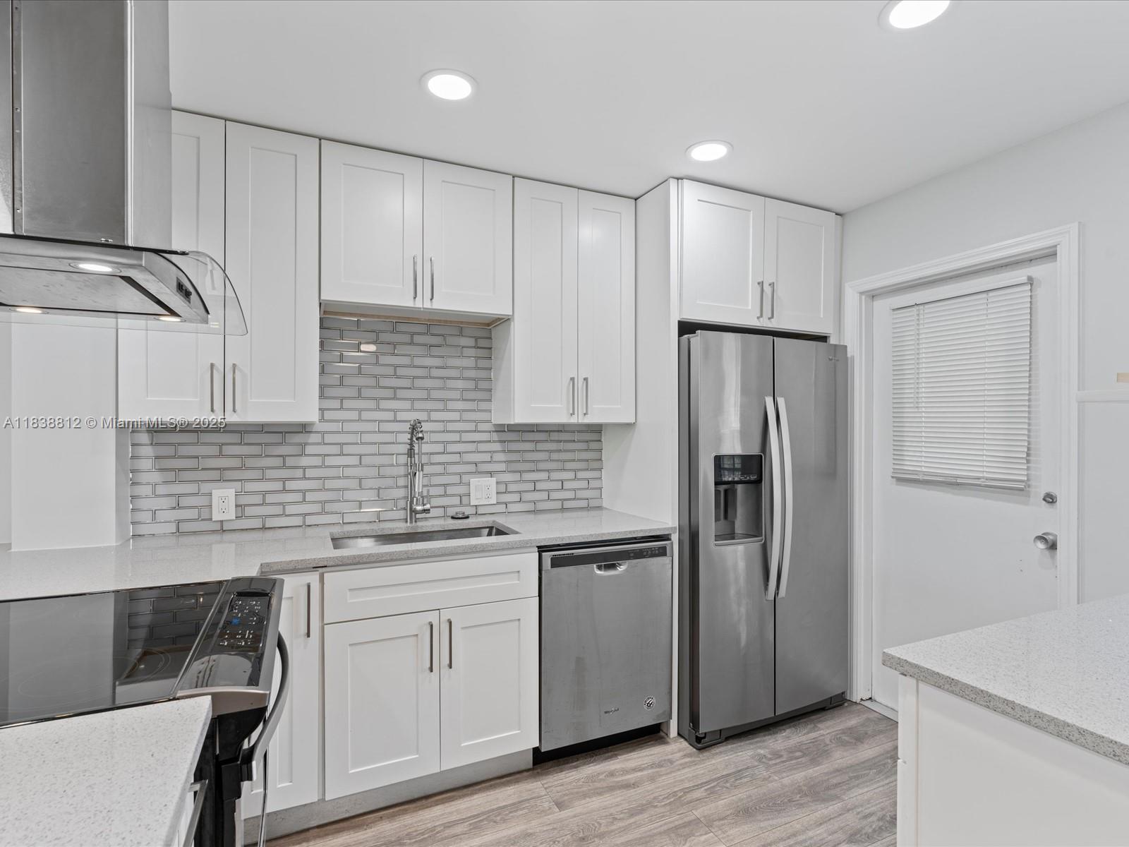 Palm Aire Pompano Beach, FL 33069 - Photo 4 of 26 a kitchen with a refrigerator sink and cabinets