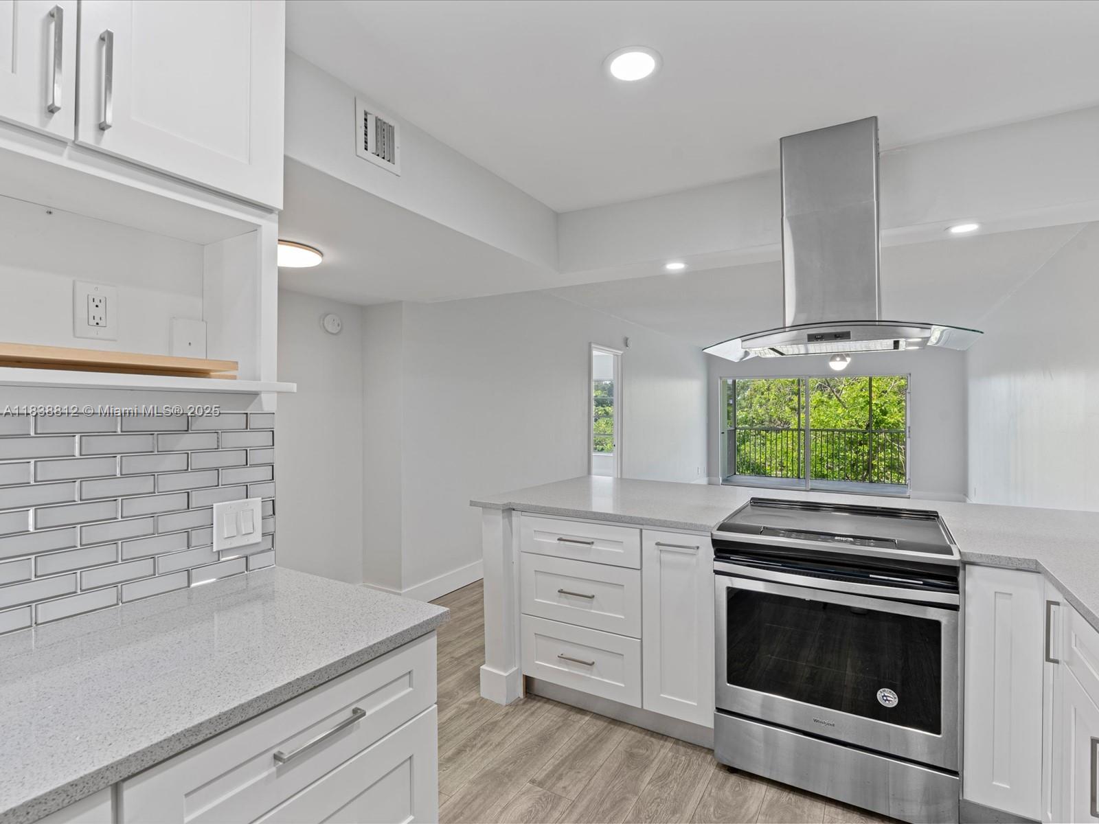 Palm Aire Pompano Beach, FL 33069 - Photo 6 of 26 a kitchen with stainless steel appliances white cabinets and a stove top oven