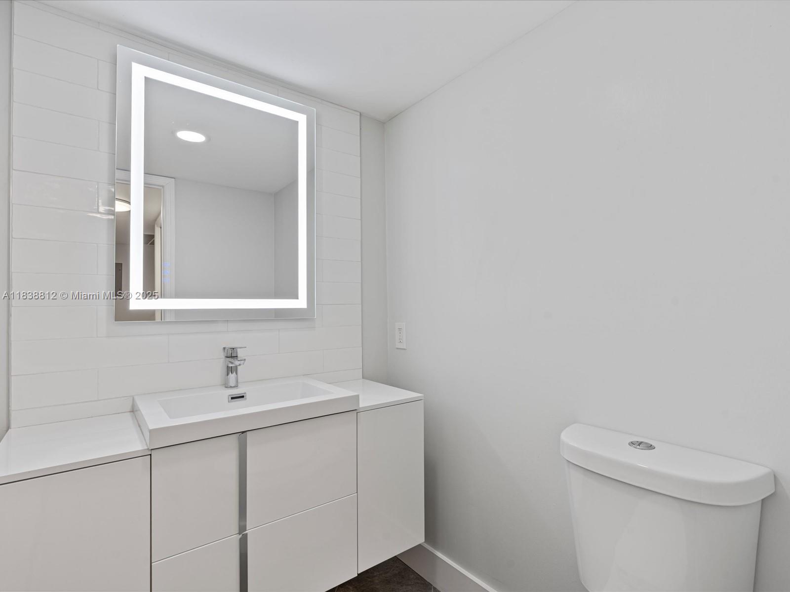 Palm Aire Pompano Beach, FL 33069 - Photo 8 of 26 a bathroom with a sink a toilet and mirror