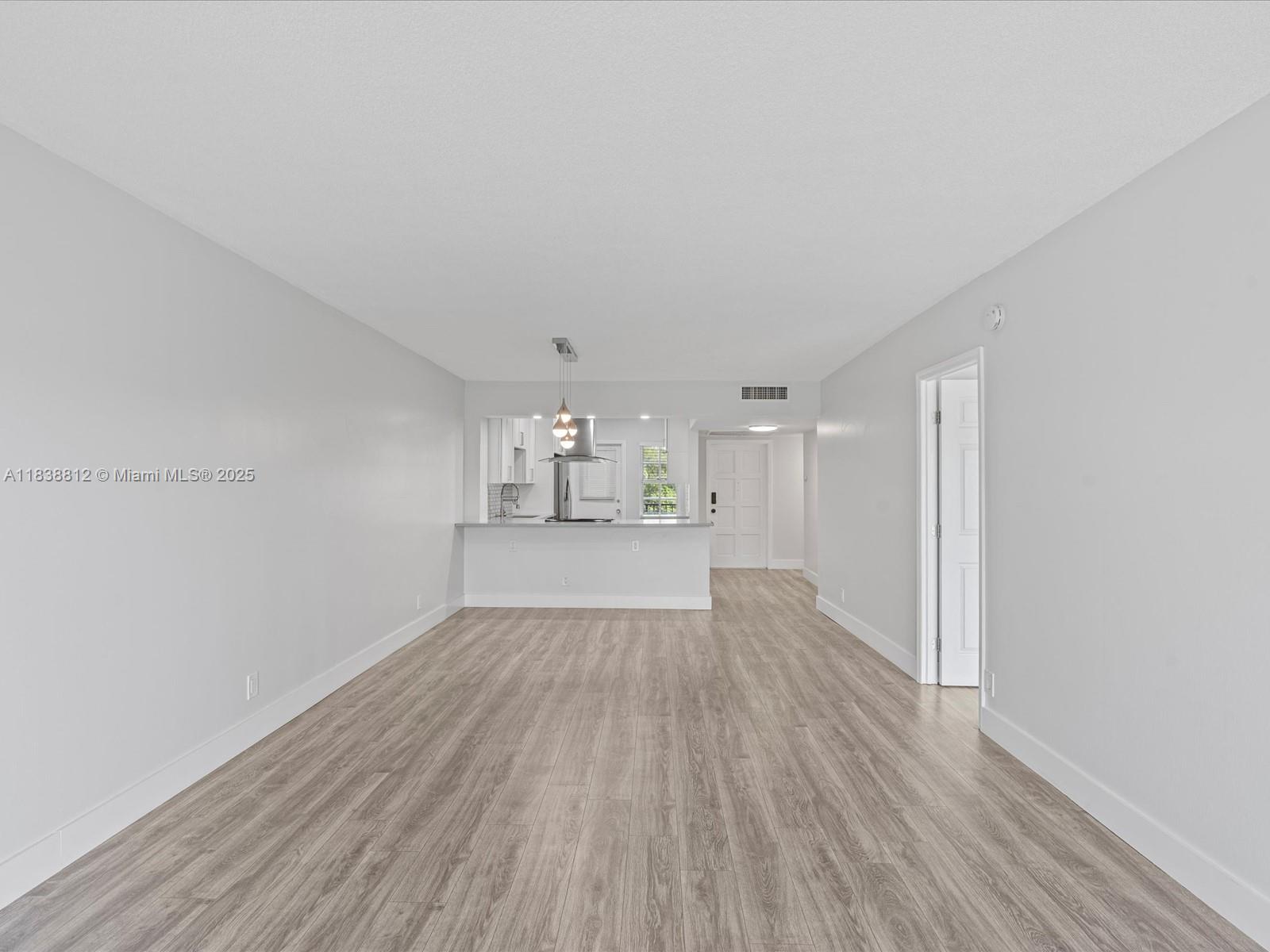 Palm Aire Pompano Beach, FL 33069 - Photo 9 of 26 a view of empty room with wooden floor