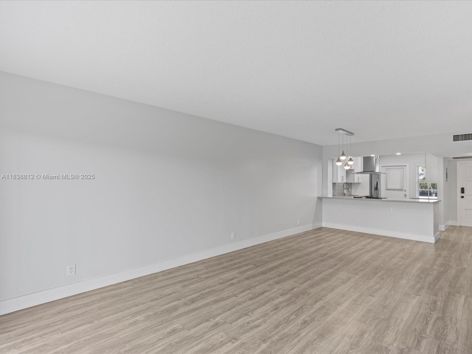 Palm Aire Pompano Beach, FL 33069 - Photo 10 of 26 a view of empty room with wooden floor