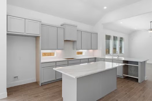 22534 Basswood Bnd Road Waller, TX 77484 - Photo 2 of 8 a kitchen with stainless steel appliances granite countertop a sink and a refrigerator