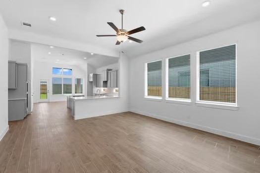 22534 Basswood Bnd Road Waller, TX 77484 - Photo 3 of 8 a view of an empty room with a window and wooden floor