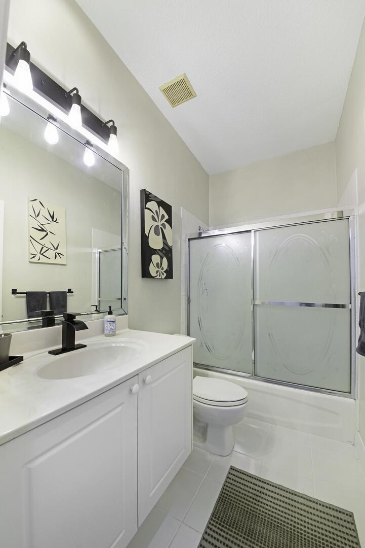 8214 Bellafiore Way Boynton Beach, FL 33472 - Photo 16 of 35 a bathroom with a sink a toilet and shower