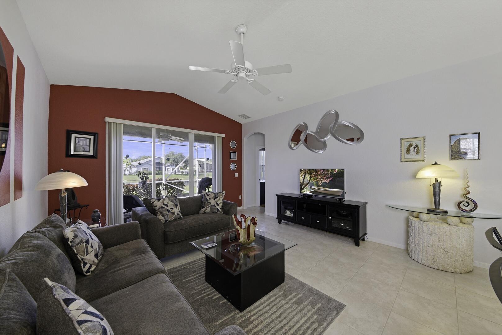 8214 Bellafiore Way Boynton Beach, FL 33472 - Photo 3 of 35 a living room with furniture a chandelier and a window