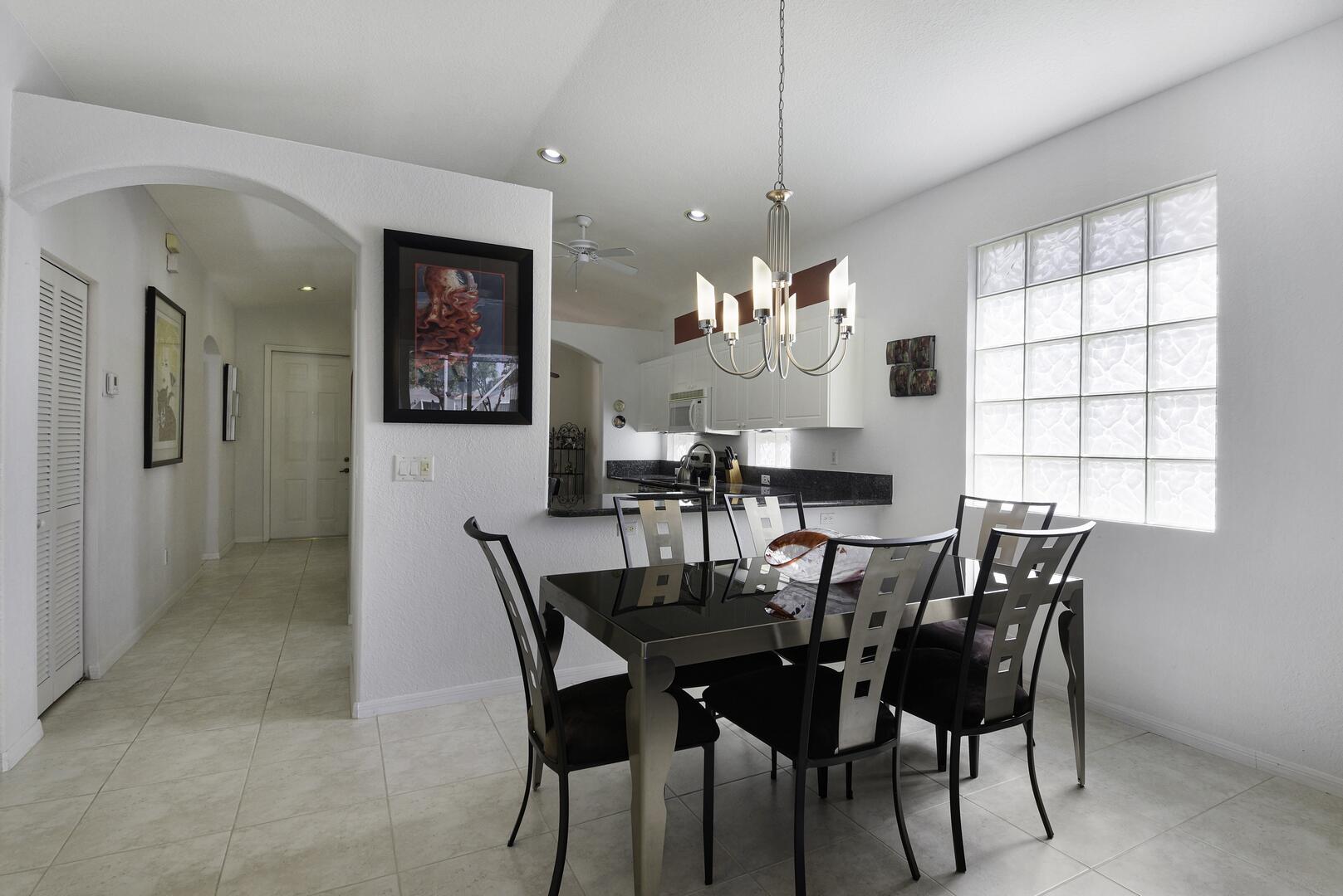 8214 Bellafiore Way Boynton Beach, FL 33472 - Photo 5 of 35 a view of a dining room with furniture and chandelier