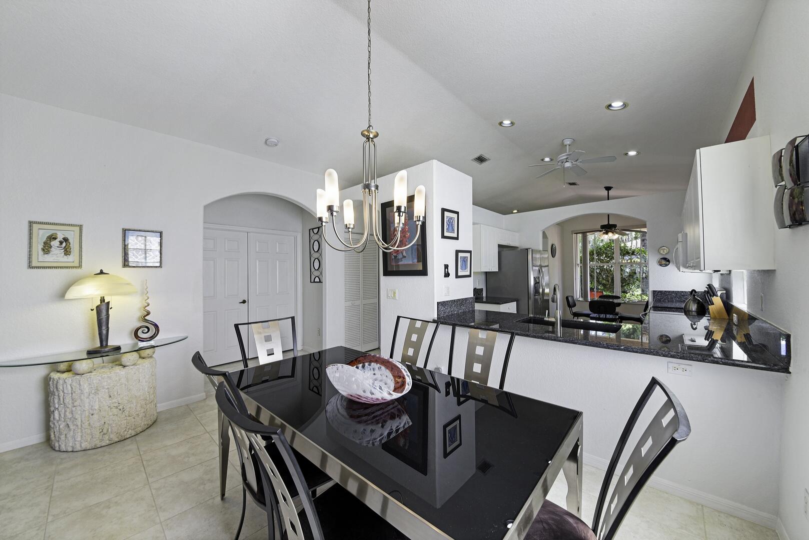8214 Bellafiore Way Boynton Beach, FL 33472 - Photo 35 of 35 a view of kitchen and dining area with chandelier