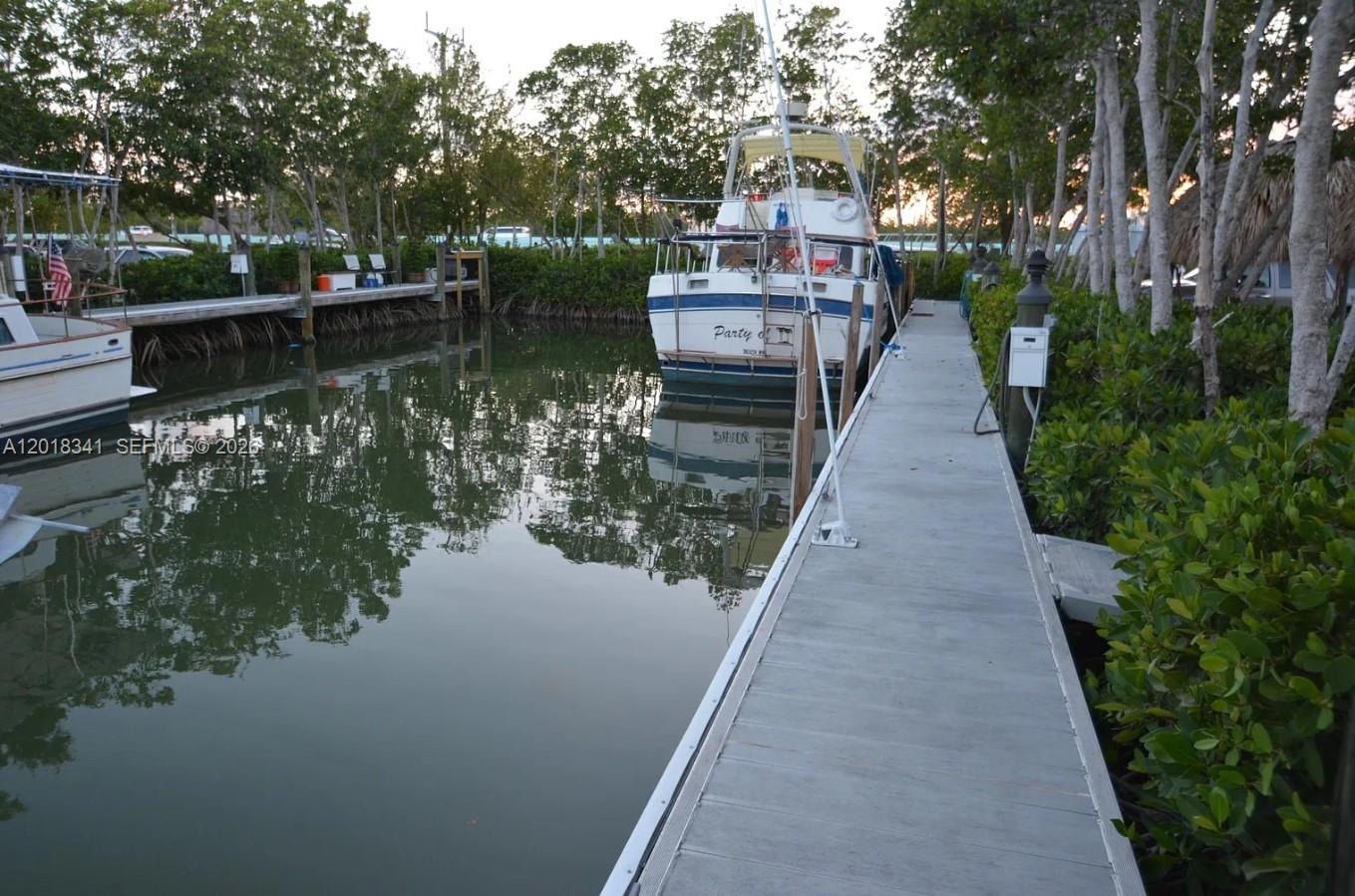 100 Morris Lane Key Largo, FL 33037 - Photo 4 of 10 a view of a house with wooden deck next to a lake