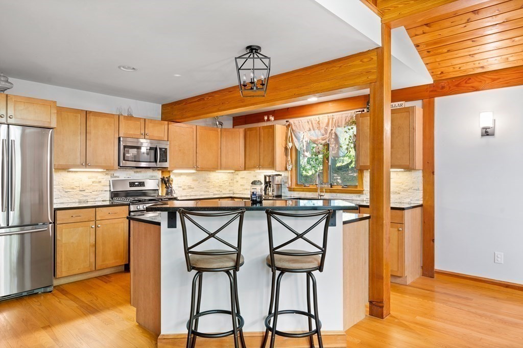 56 Southampton Road Westhampton, MA 01027 - Photo 14 of 42 a kitchen with stainless steel appliances granite countertop a refrigerator and wooden cabinets