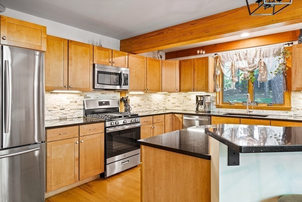 56 Southampton Road Westhampton, MA 01027 - Photo 15 of 42 a kitchen with stainless steel appliances granite countertop a refrigerator a stove and a sink with wooden floor