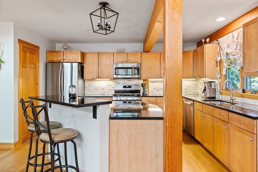 56 Southampton Road Westhampton, MA 01027 - Photo 16 of 42 a kitchen with stainless steel appliances wooden floor and a refrigerator