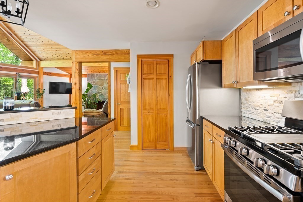 56 Southampton Road Westhampton, MA 01027 - Photo 18 of 42 a kitchen with stainless steel appliances a stove top oven and a refrigerator