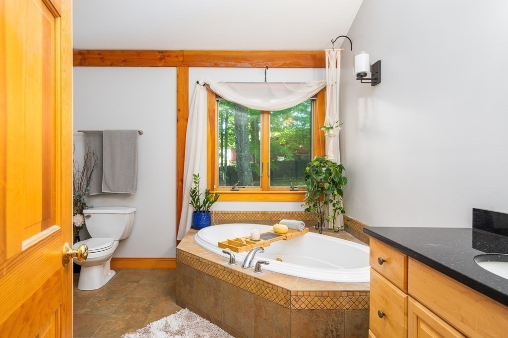 56 Southampton Road Westhampton, MA 01027 - Photo 25 of 42 a bathroom with a tub sink and mirror