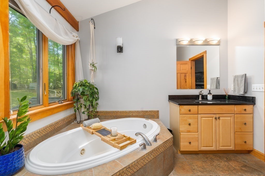 56 Southampton Road Westhampton, MA 01027 - Photo 26 of 42 a bathroom with a tub a sink and mirror