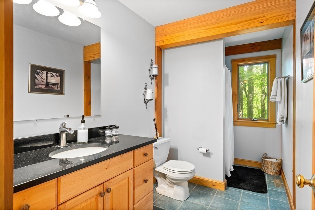 56 Southampton Road Westhampton, MA 01027 - Photo 33 of 42 a bathroom with a granite countertop sink vanity mirror and toilet