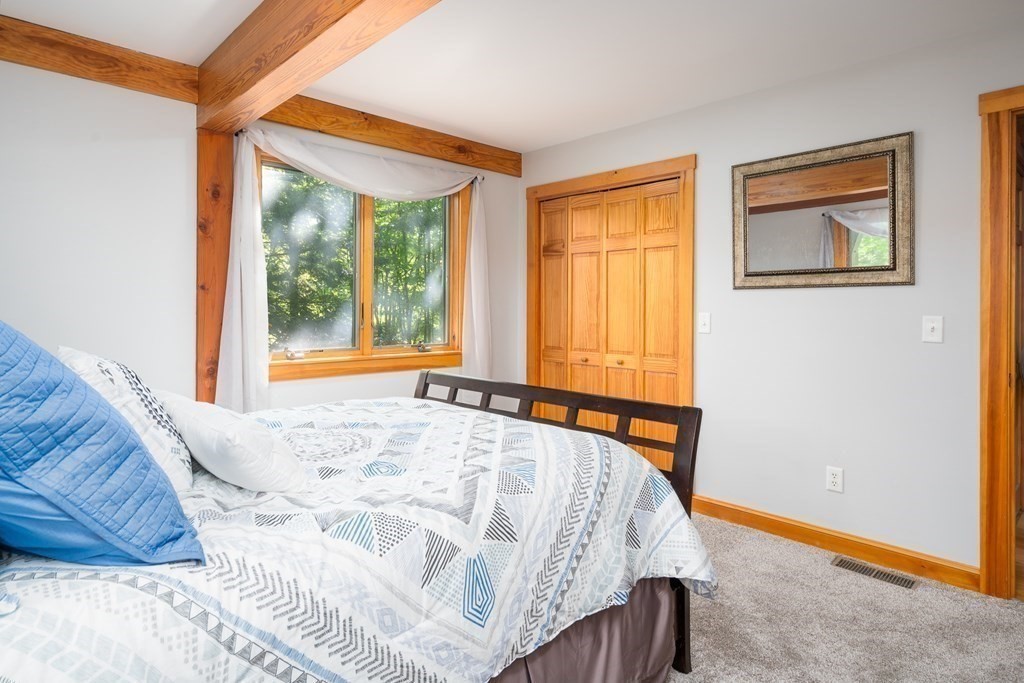 56 Southampton Road Westhampton, MA 01027 - Photo 37 of 42 a bed sitting in a bedroom next to a window