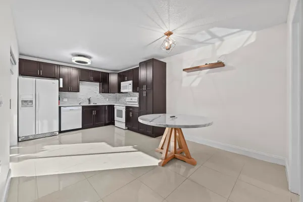 a kitchen with stainless steel appliances a refrigerator and microwave