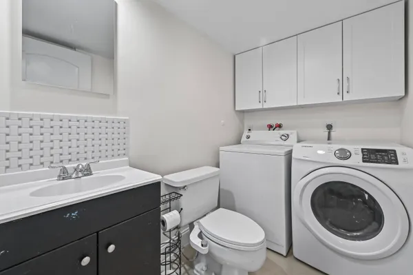 a bathroom with a sink toilet and vanity