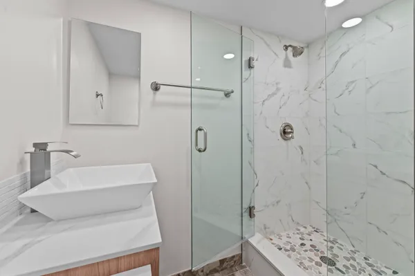 a bathroom with a shower and a sink