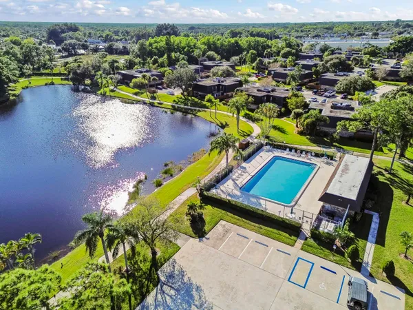 an aerial view of a house with a swimming pool yard and outdoor seating