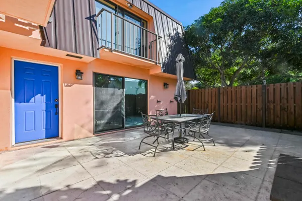 a table and chair in front of a house