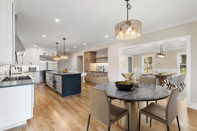 a kitchen with a dining table and chairs