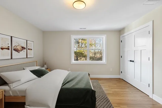 a bedroom with a bed and a window