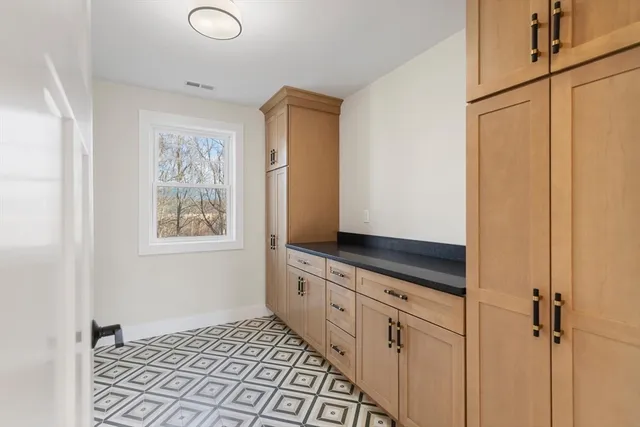 a kitchen with granite countertop a sink and a stove top oven