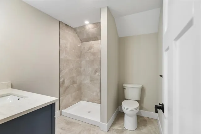 a bathroom with a toilet sink and shower