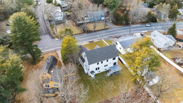 an aerial view of a house with a swimming pool and outdoor seating