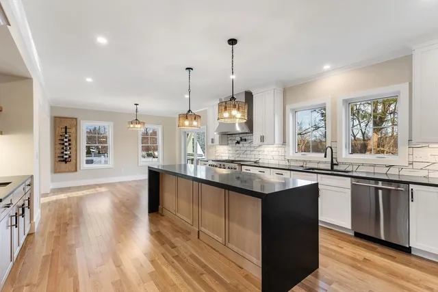 a kitchen with granite countertop a sink and wooden floor