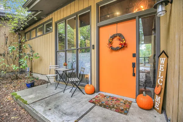 a living room with furniture a wooden floor and next to a window
