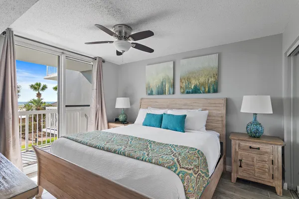 a bedroom with a large bed and a flat tv screen on dresser