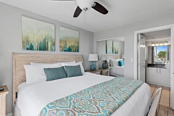 a bathroom with a sink a mirror and a potted plant