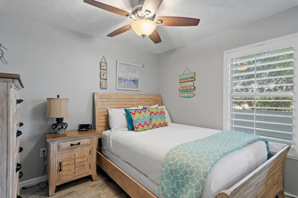 a bedroom with a bed a mirror and a window