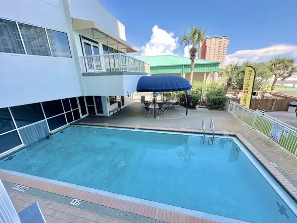 a view of a patio with swimming pool table and chairs