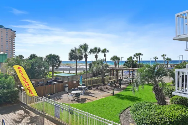 a view of a swimming pool with a patio and a garden